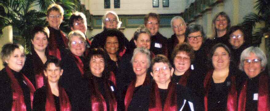 20 happy singers in red scarves