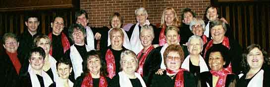 21 laughing singers in scarves with hearts