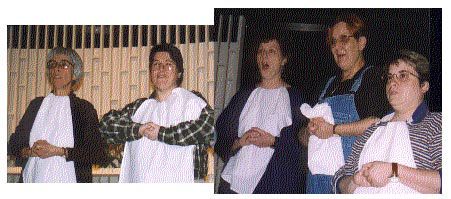 5 singers wearing napkins as bibs